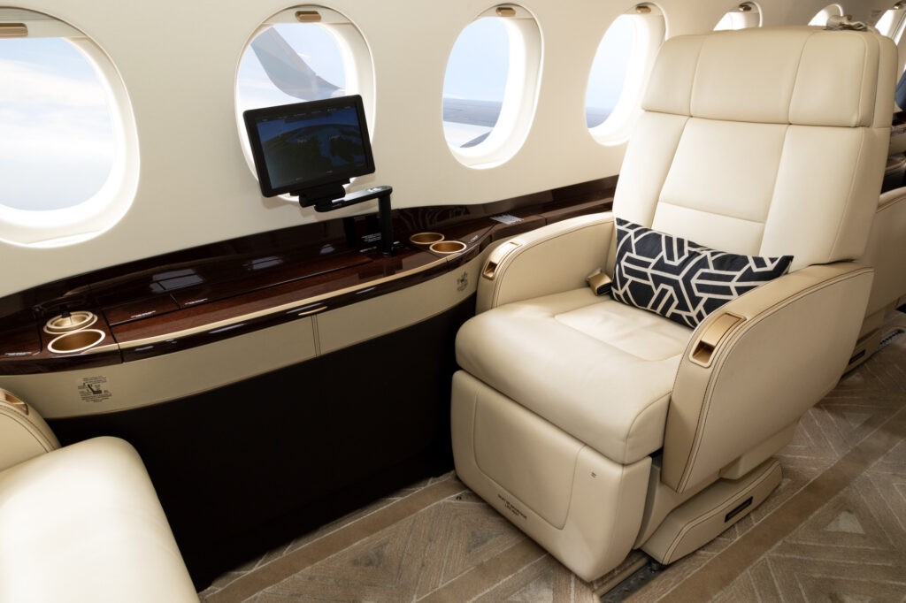 Comfortible cabin chair in a modern business jet during flight. Republic Jet Center